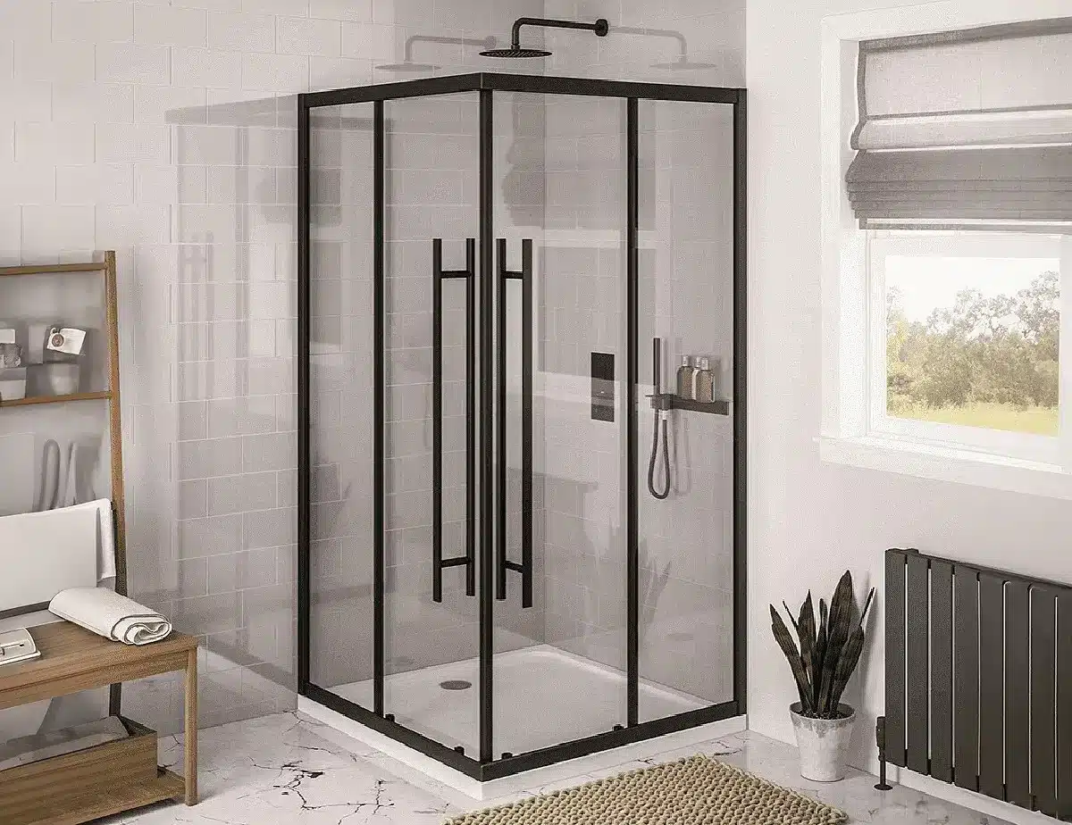 Modern bathroom with a black-framed corner entry shower enclosure featuring double sliding doors, white shower tray, rainfall showerhead, and handheld attachment. The space includes a wooden bench, tiled walls, marble-effect flooring, and a large window with a fabric blind